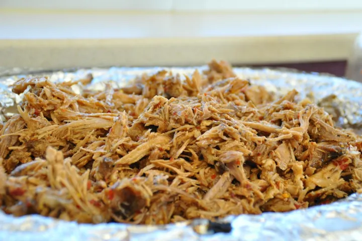 Close-up of shredded meat on foil.