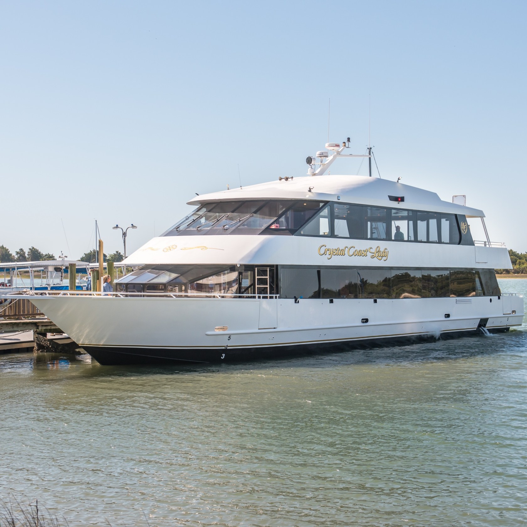 a boat is docked next to a body of water
