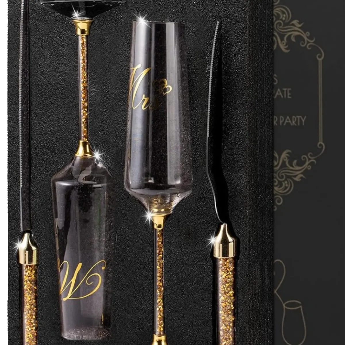 Gold and black wedding cake cutting set with glasses in a gift box.